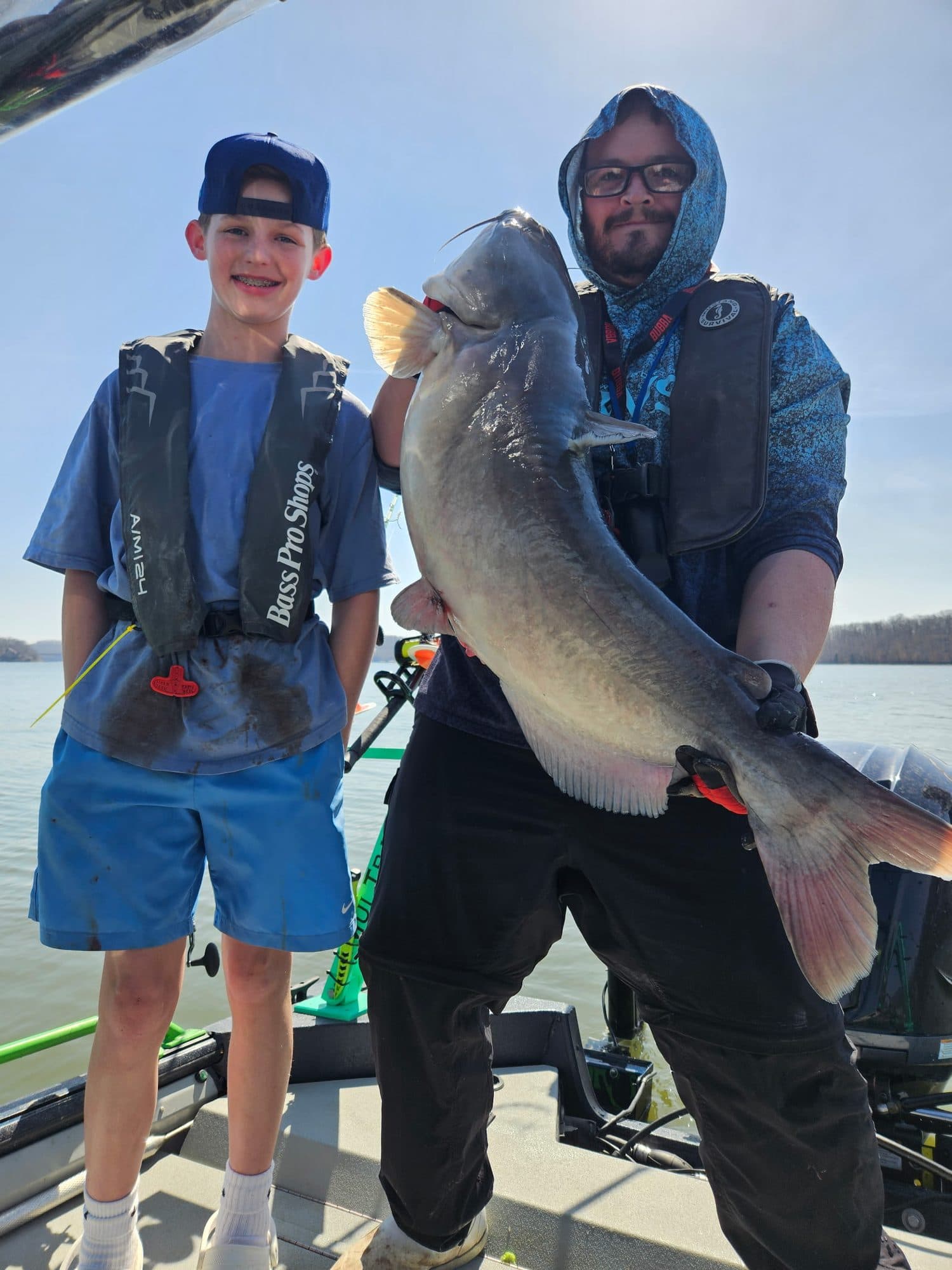 Father and son with a trophy catfish