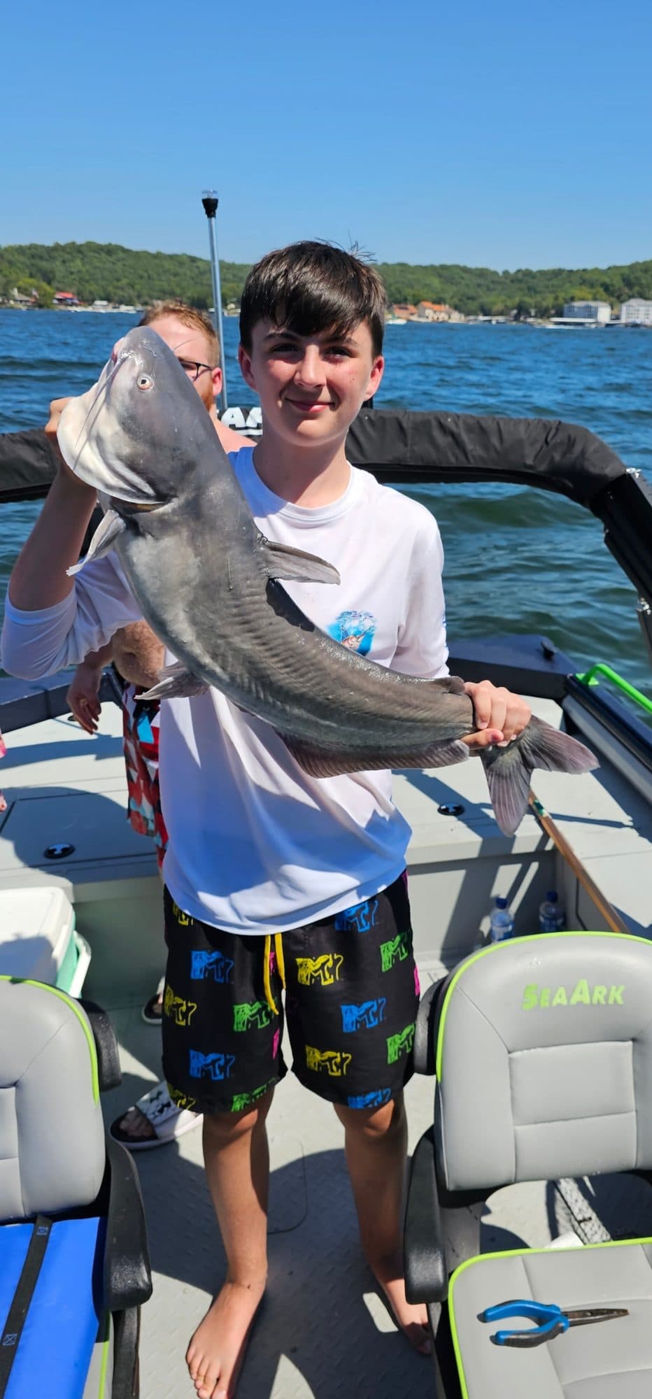 Young angler with his catfish catch