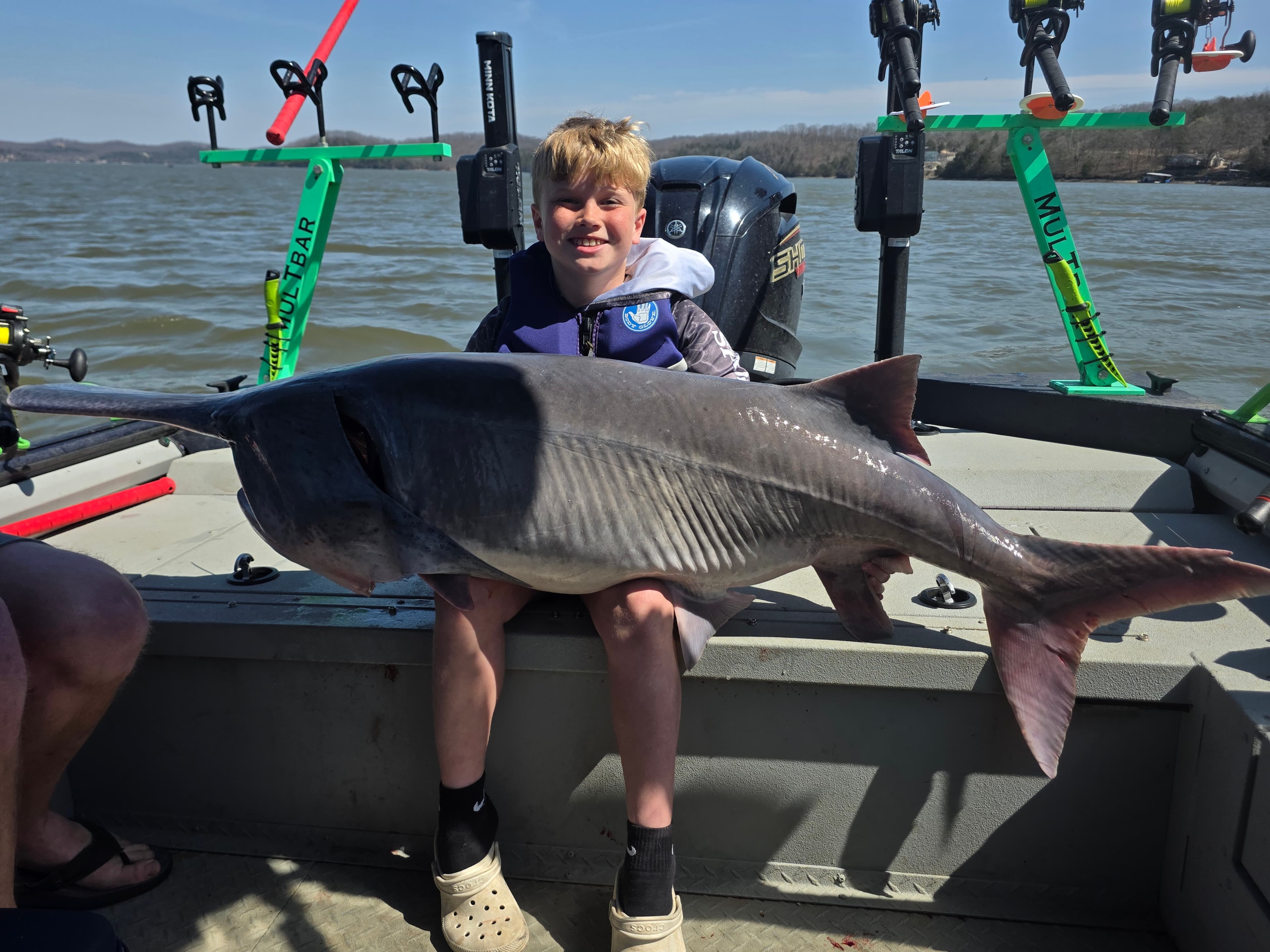 Young angler with a trophy spoonbill