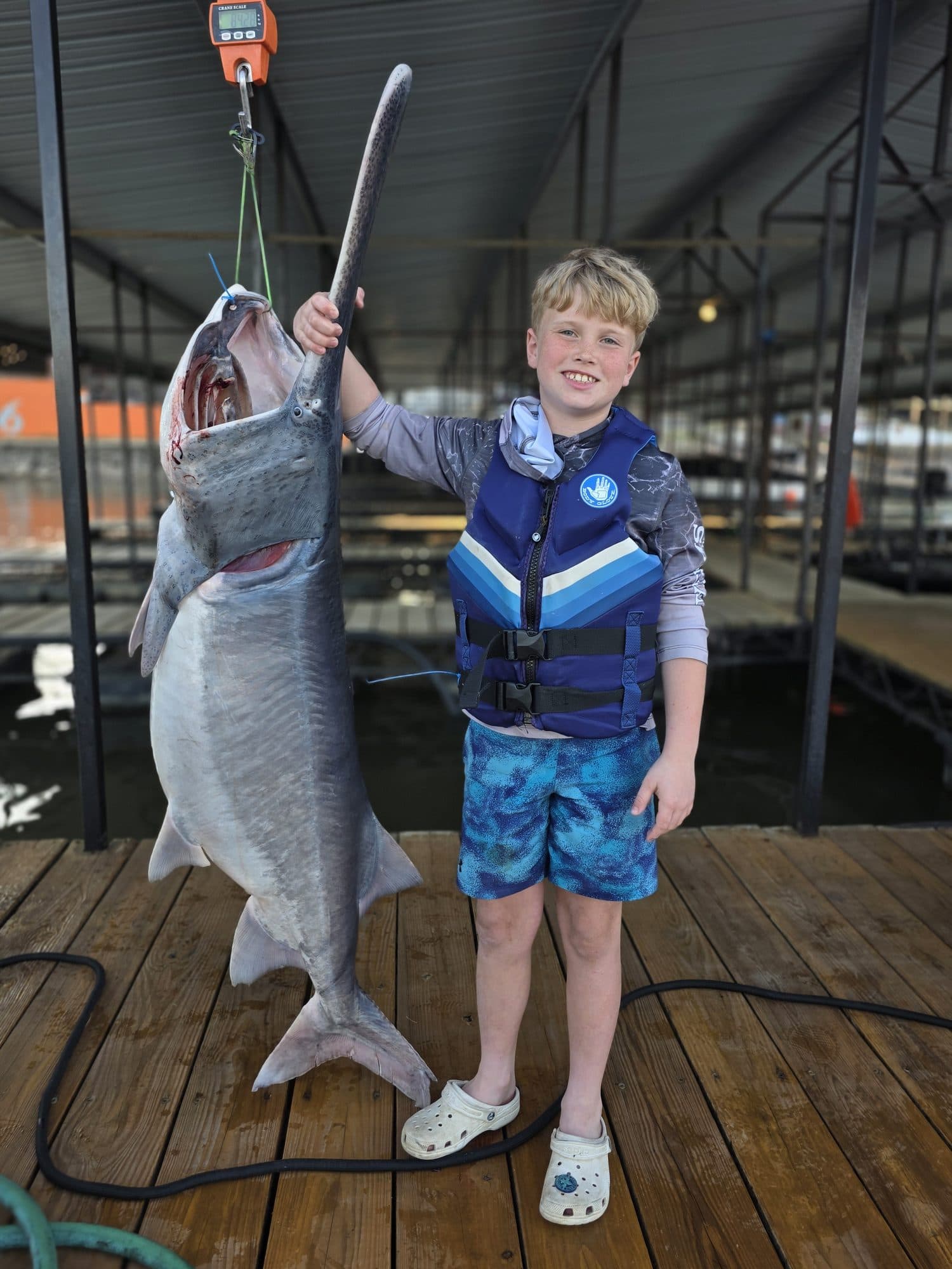 Young angler celebrating a big catch