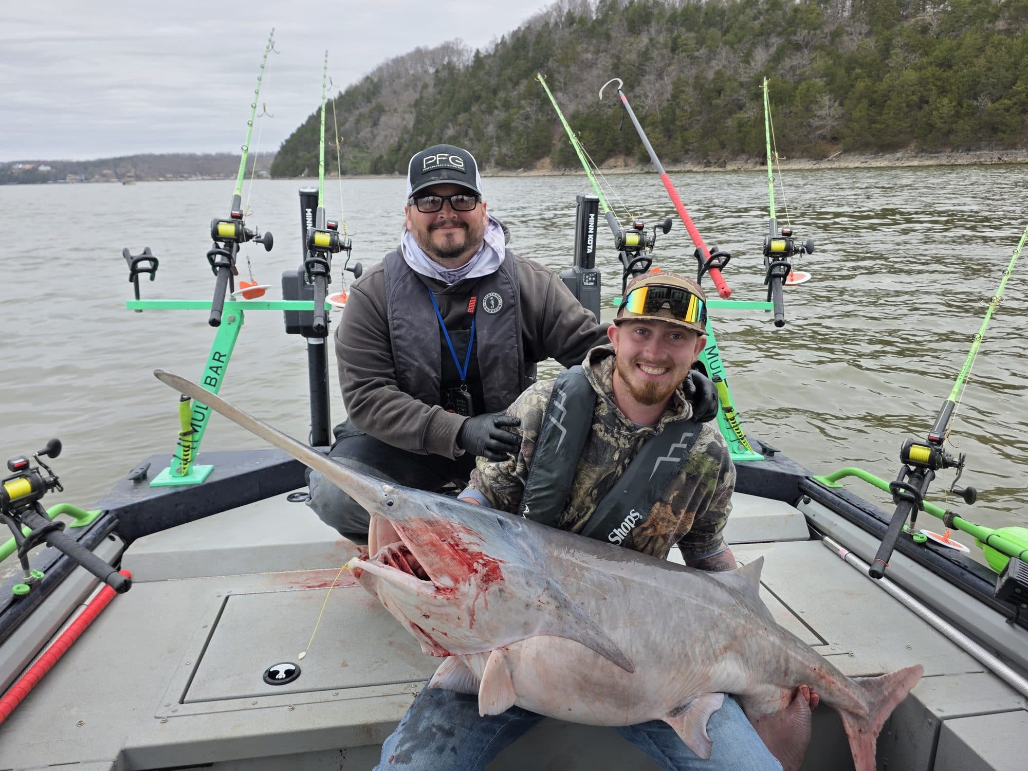 Two anglers with a trophy spoonbill